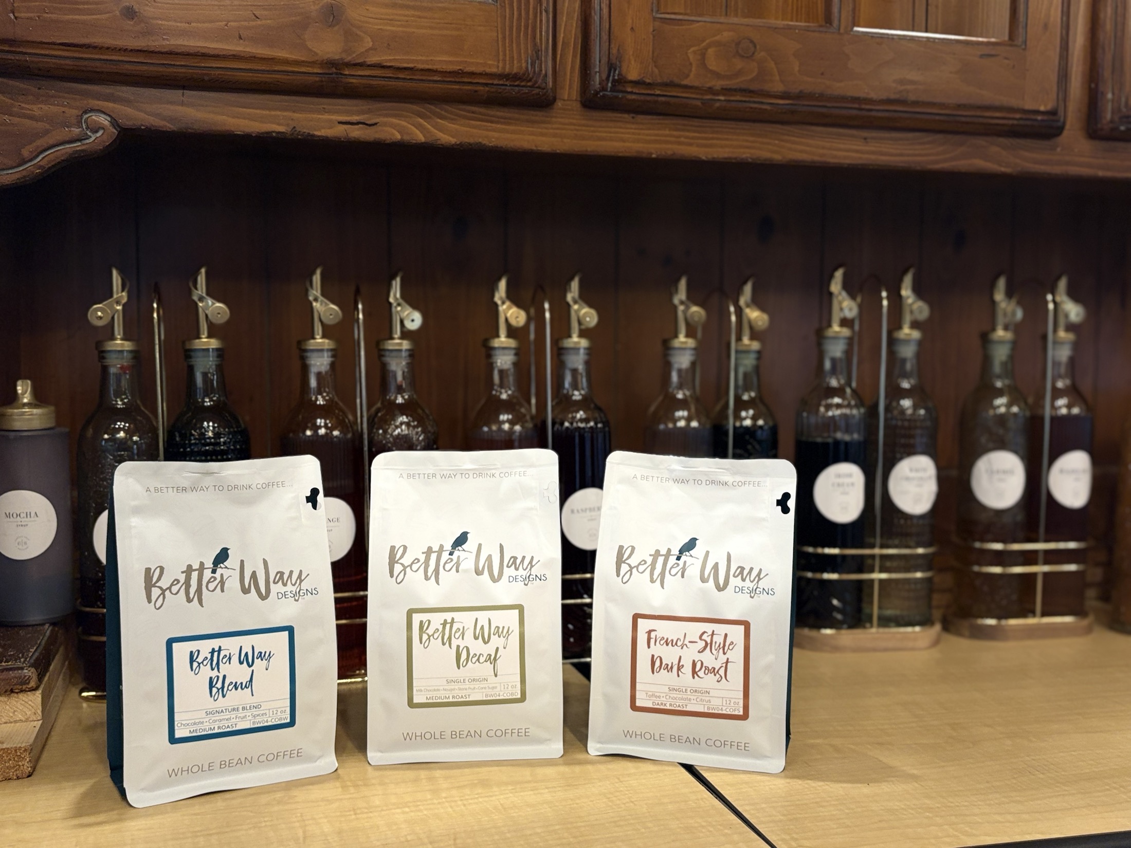 Better Way Blend, Better Way Decaf, and French-Style Dark Roast whole bean coffee bags on the 6eight shelf